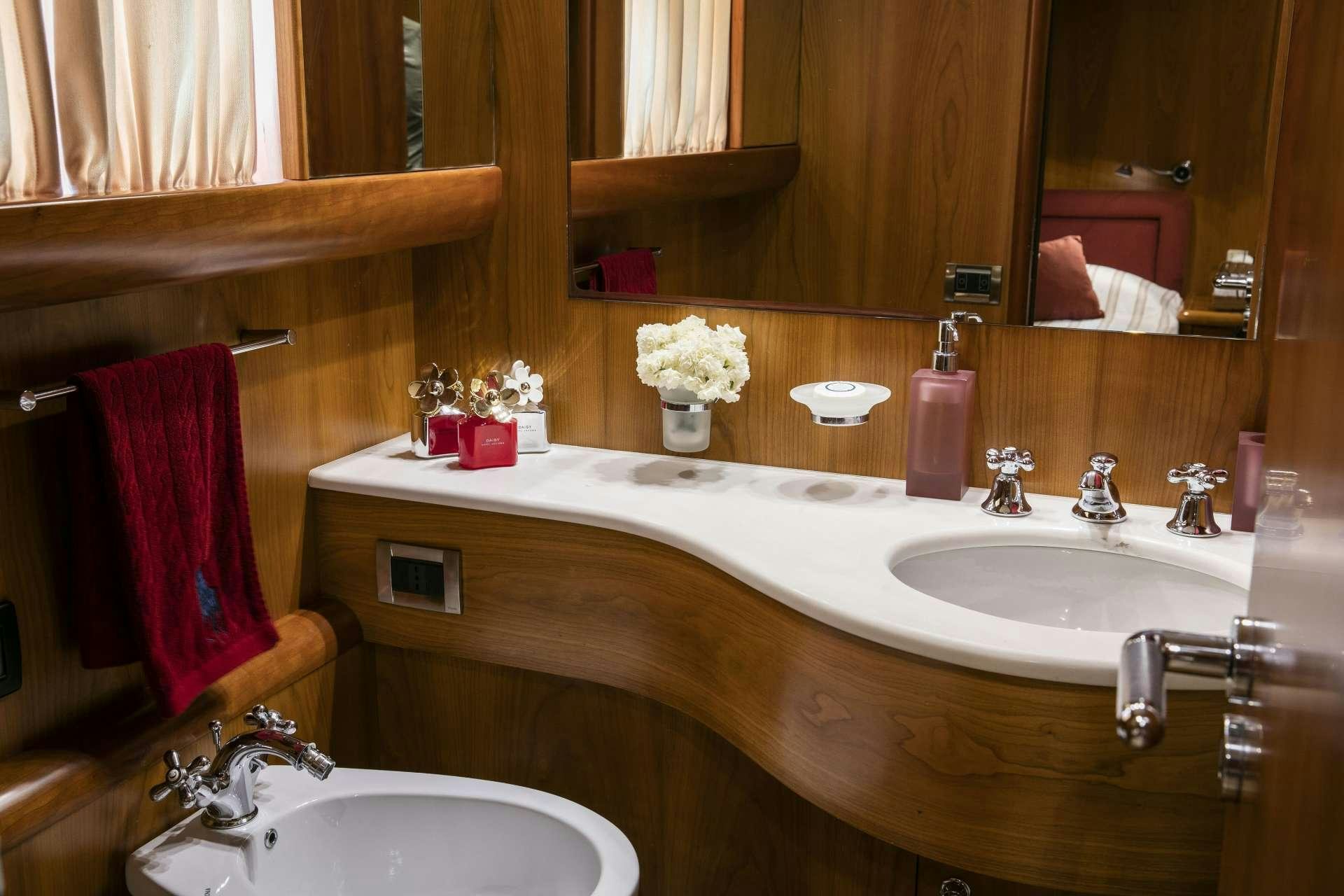 a bathroom with a sink and a mirror aboard VYNO Yacht for Charter