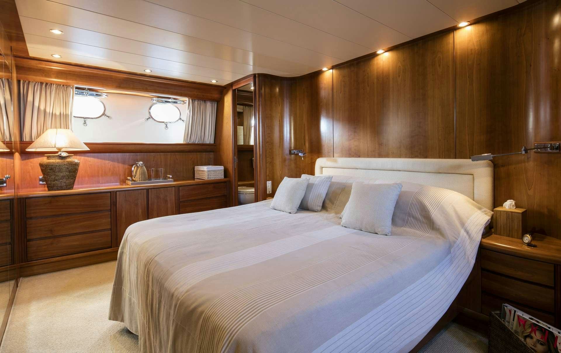 a bed with a white sheet aboard VYNO Yacht for Charter