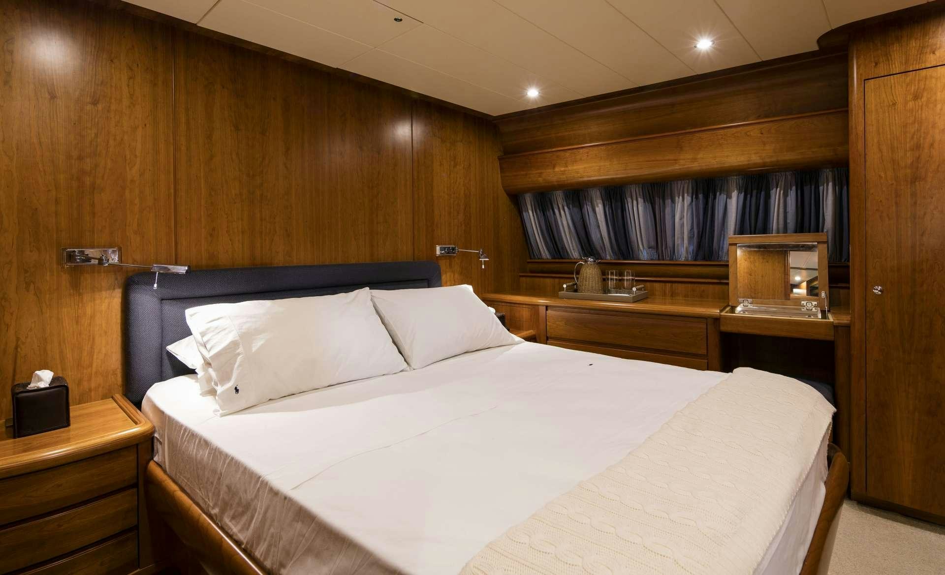 a room with a bed and a desk aboard VYNO Yacht for Charter