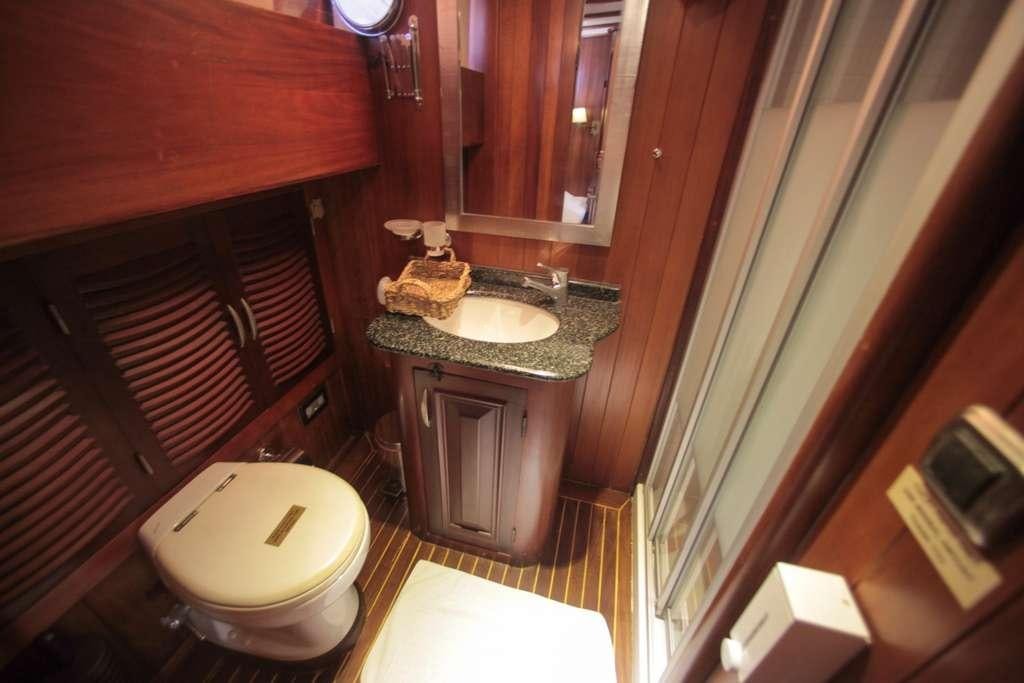 a bathroom with a sink and a toilet aboard AREA Yacht for Charter