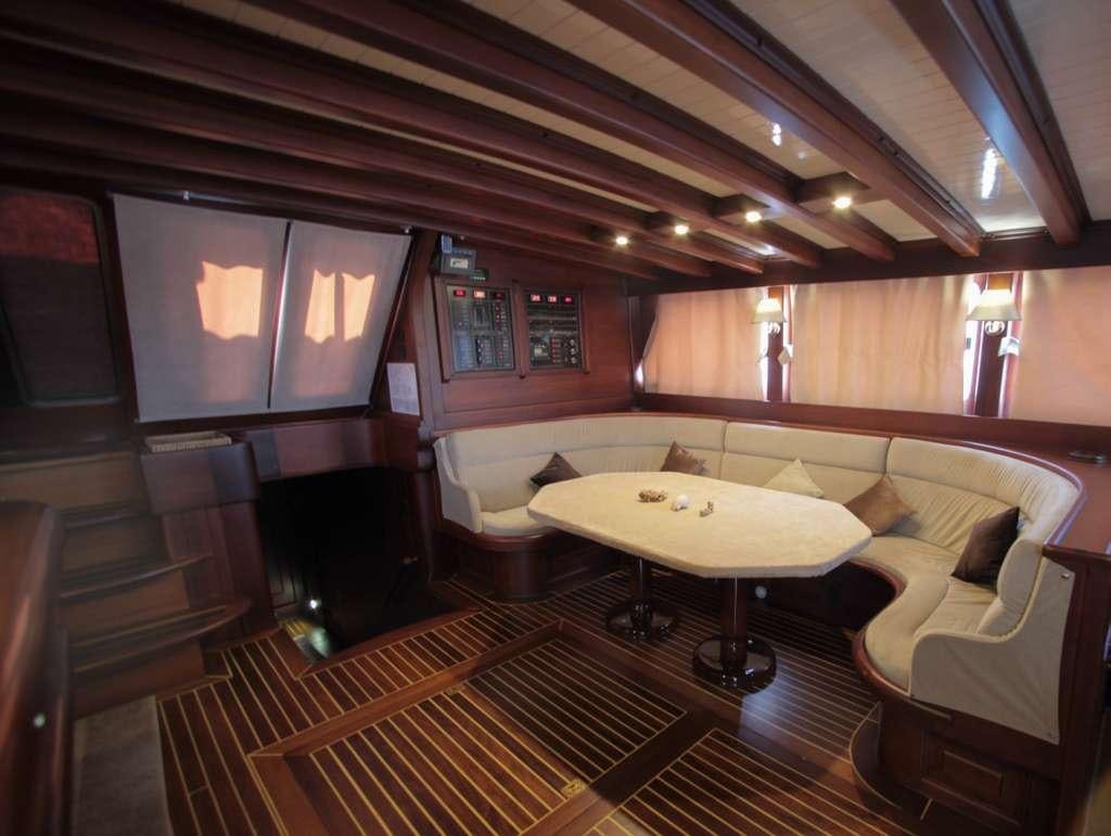 a room with a table and chairs aboard AREA Yacht for Charter
