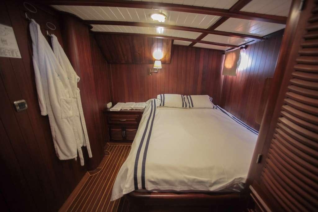 a bed in a room aboard AREA Yacht for Charter