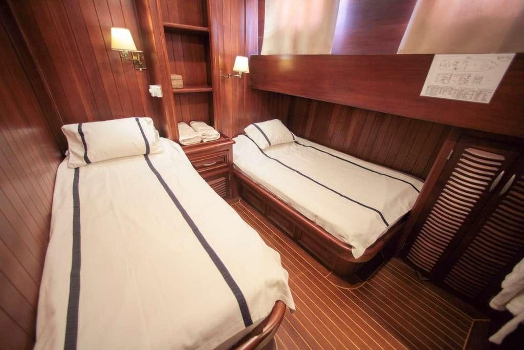 a couple of beds in a room aboard AREA Yacht for Charter