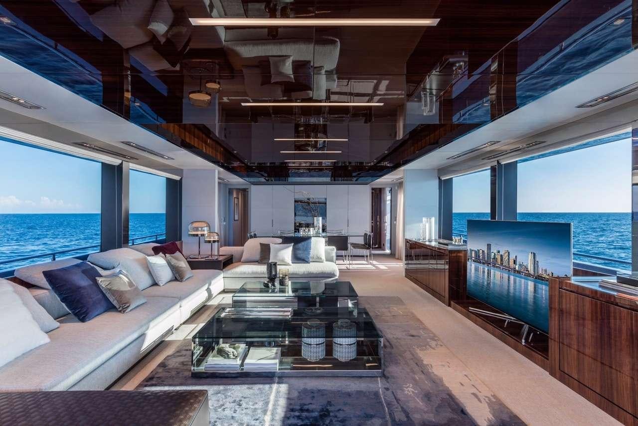 a room with a large window and a table with chairs aboard ELYSIUM I Yacht for Charter