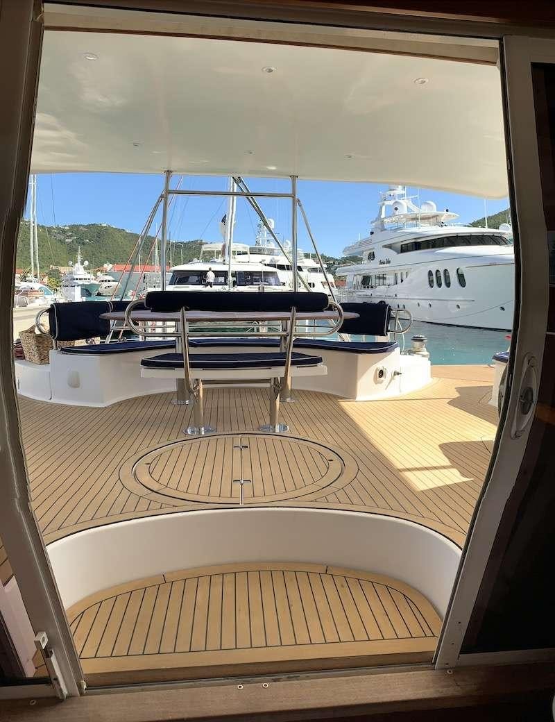 a window with a view of boats aboard VIVO Yacht for Charter