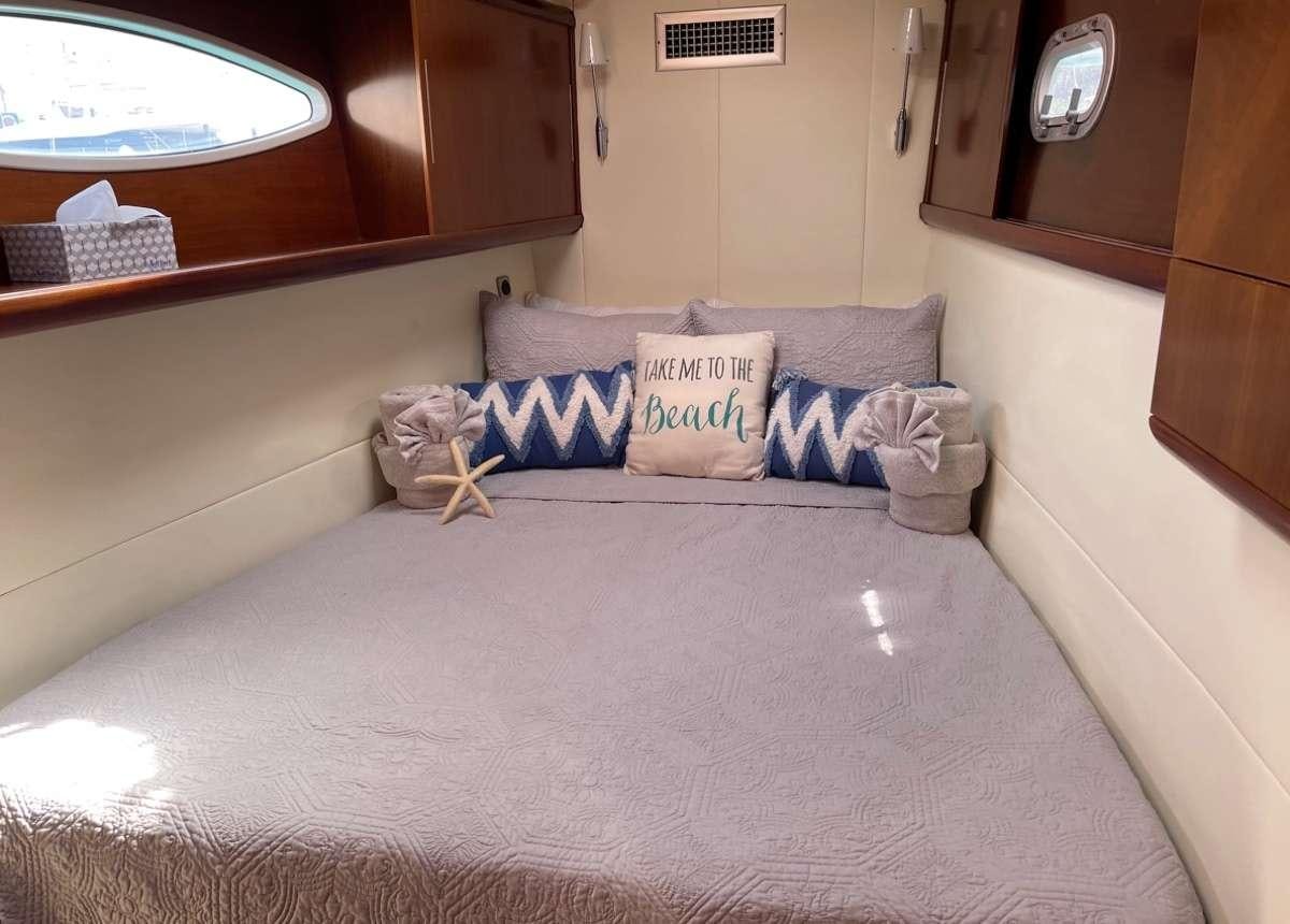 a bed with a pillow and a pillow on it aboard VIVO Yacht for Charter