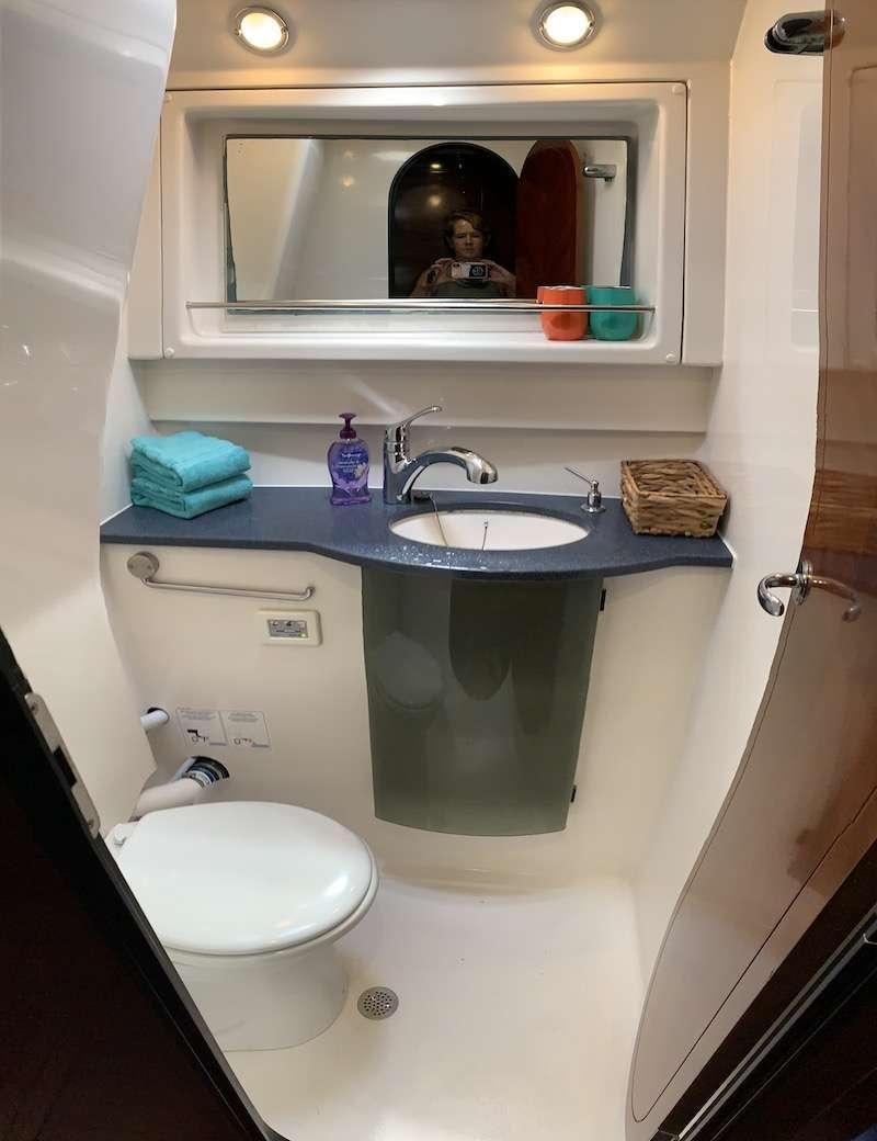 a bathroom with a sink and a mirror aboard VIVO Yacht for Charter
