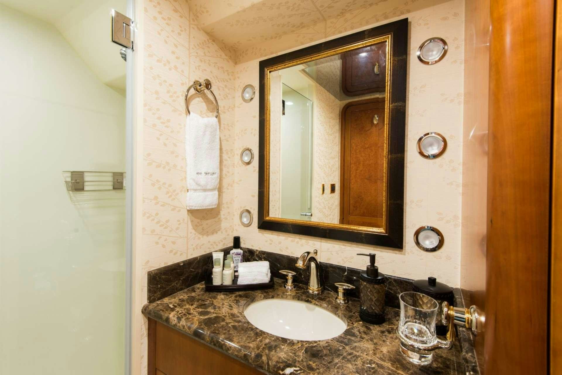 a bathroom with a mirror and a sink aboard PIPE DREAMS Yacht for Charter