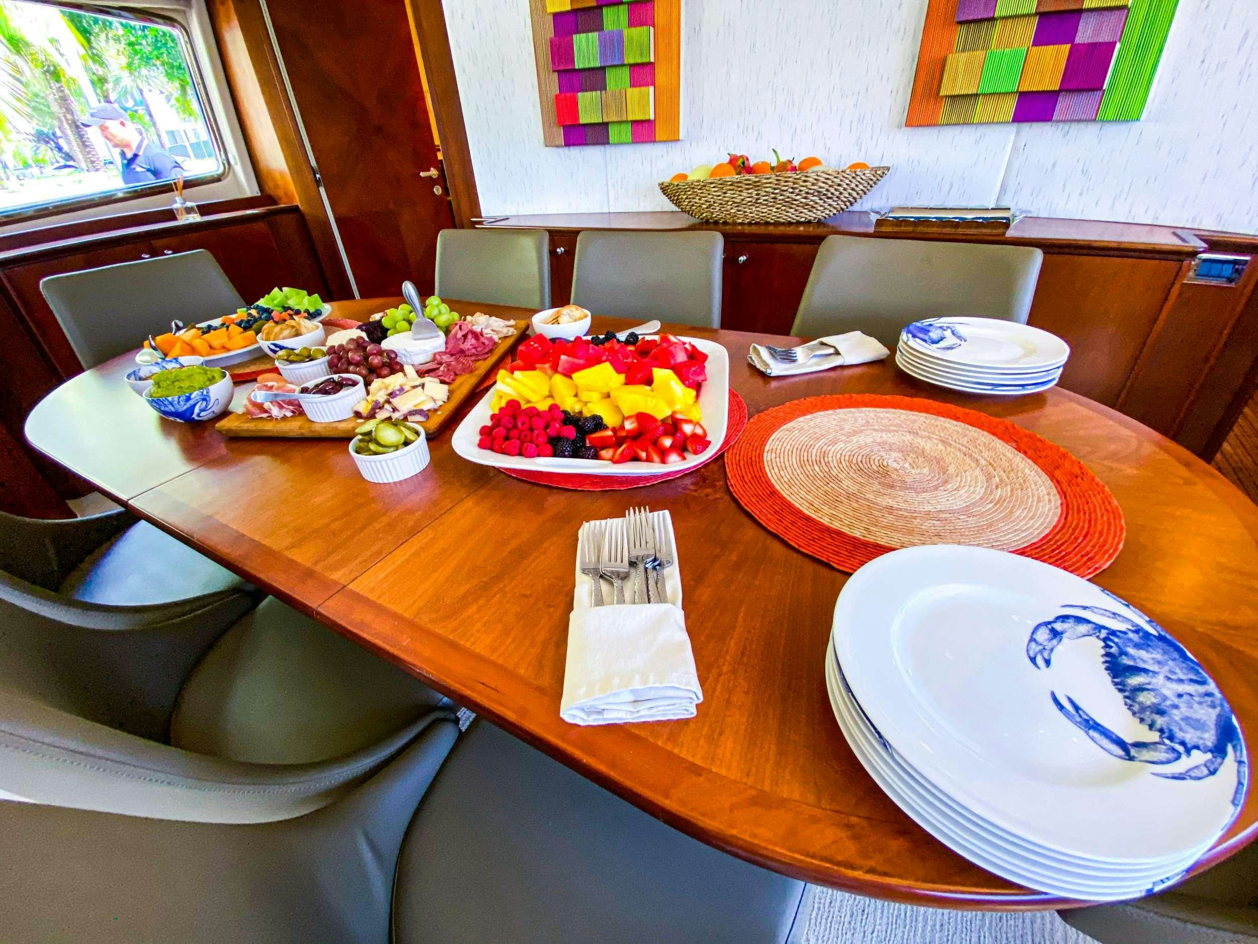 a table with plates and food on it aboard REFLECTIONS Yacht for Charter