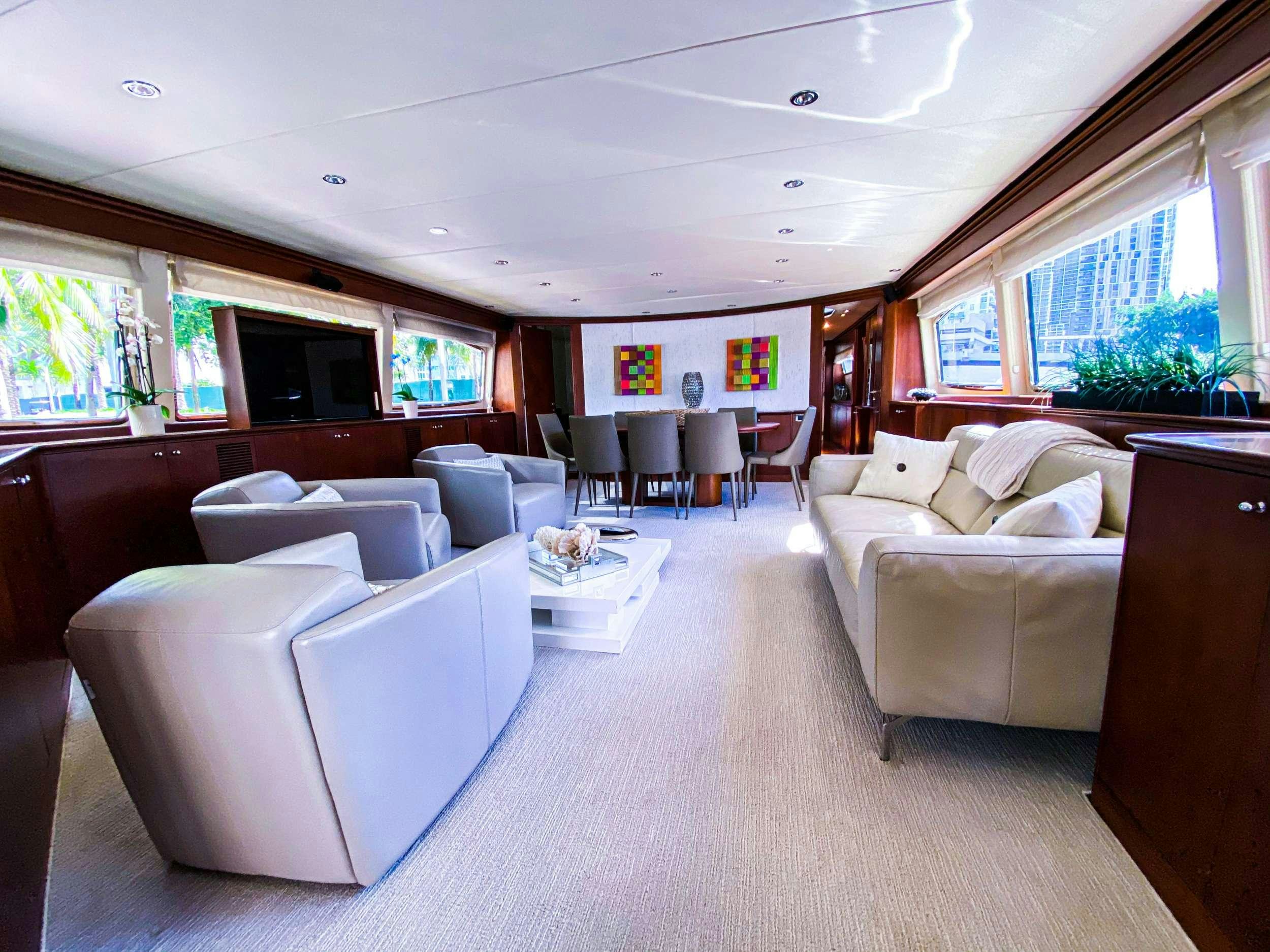 a living room with a couch and a table aboard REFLECTIONS Yacht for Charter