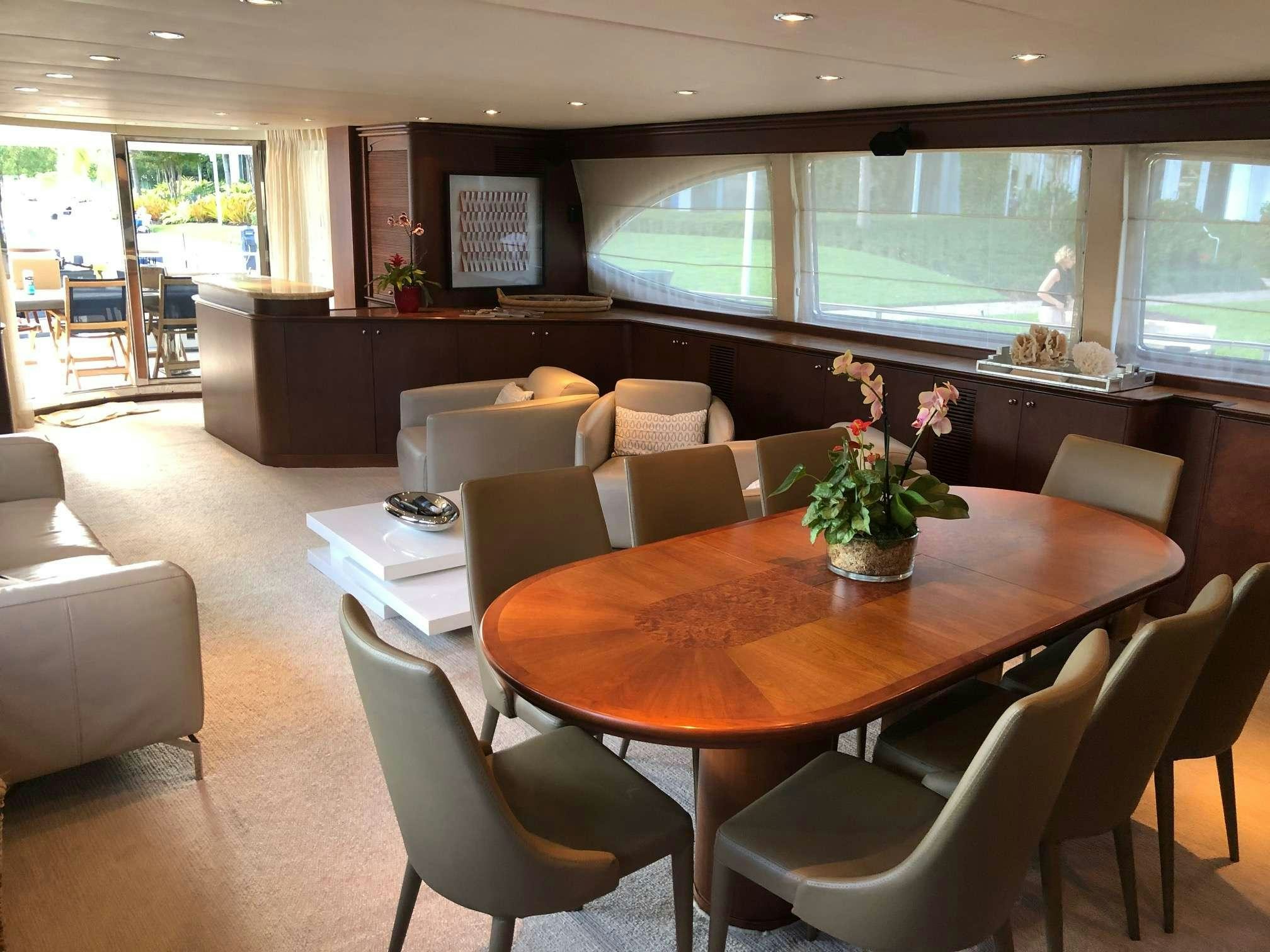 a large room with a table and chairs aboard REFLECTIONS Yacht for Charter