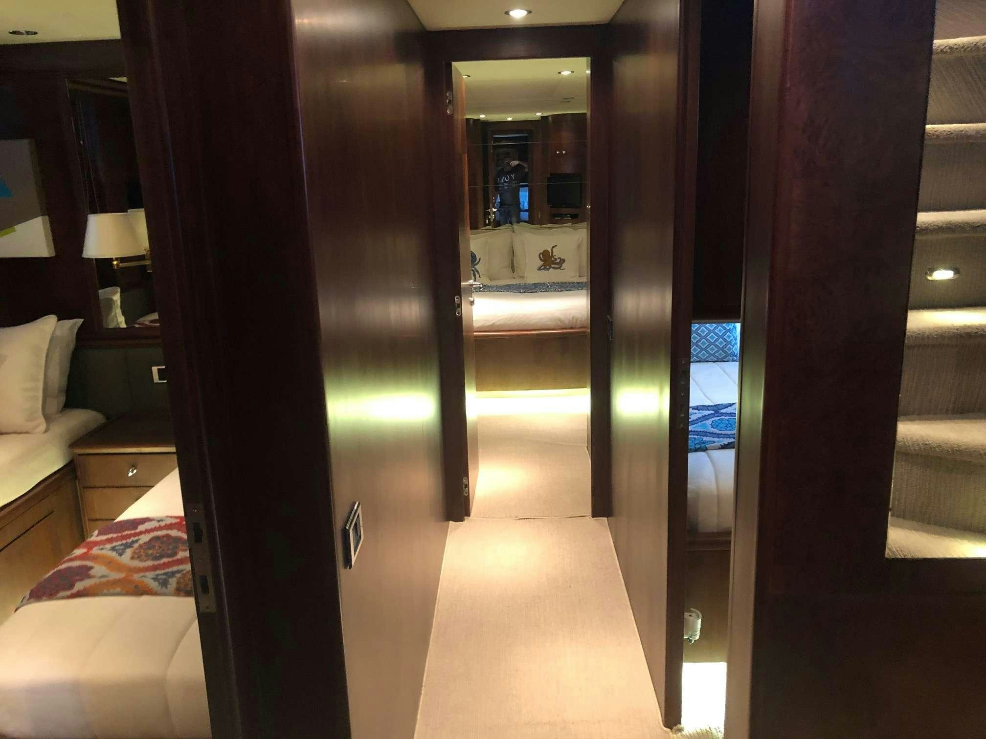 a room with a bed and a mirror aboard REFLECTIONS Yacht for Charter