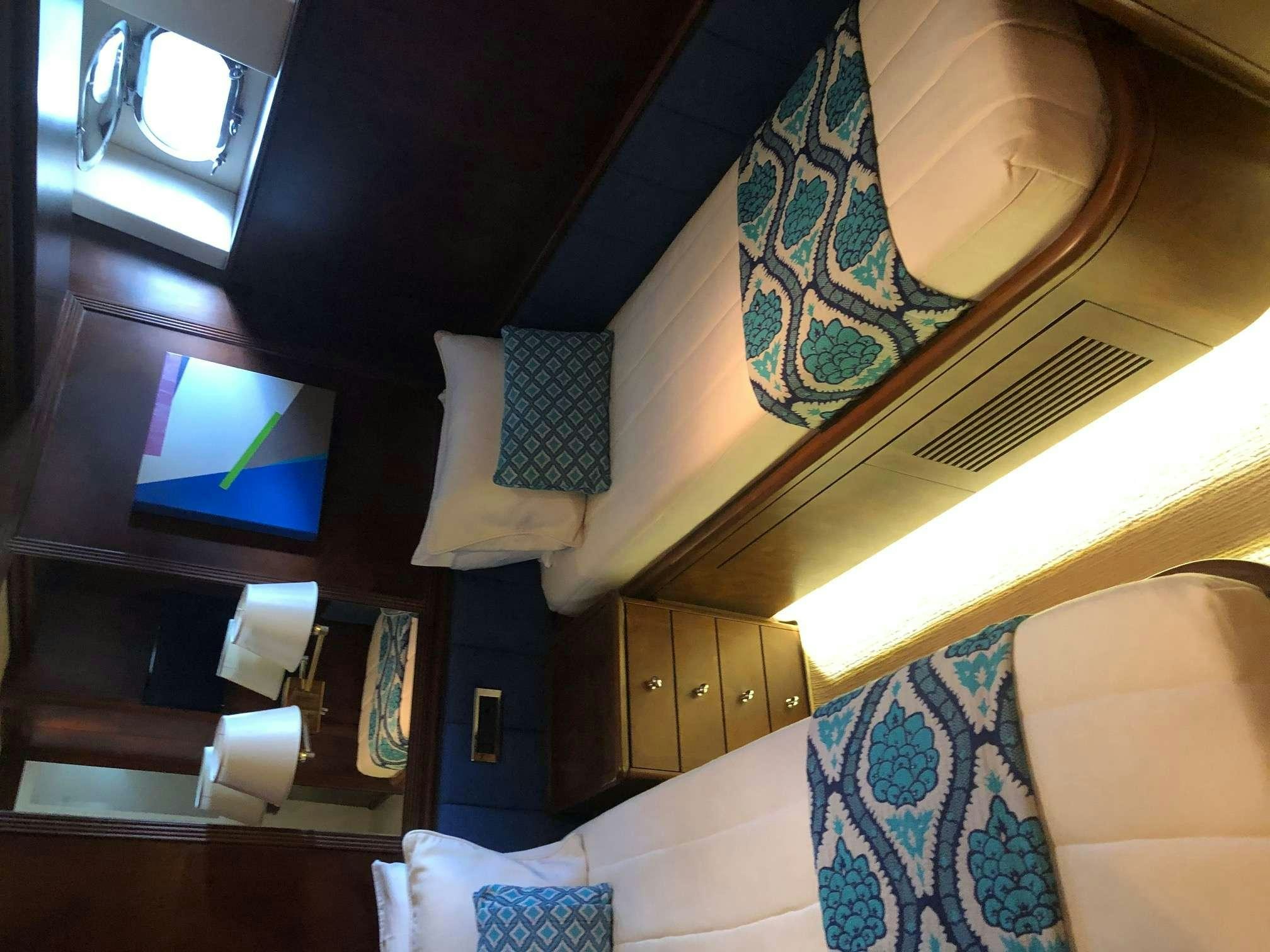 a room with a tv and a shelf with a rug and a rug aboard REFLECTIONS Yacht for Charter