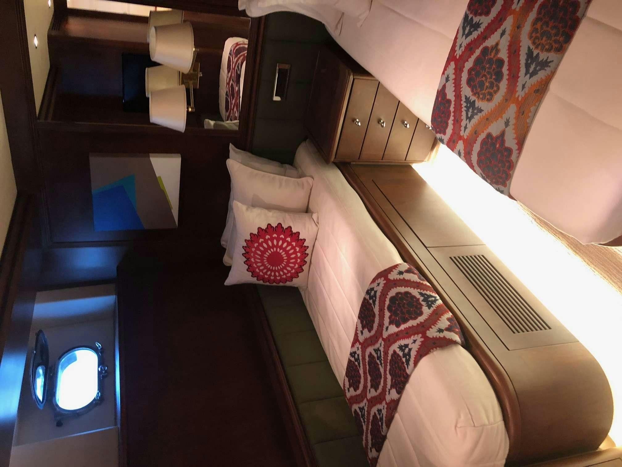 a room with a bed and a window aboard REFLECTIONS Yacht for Charter