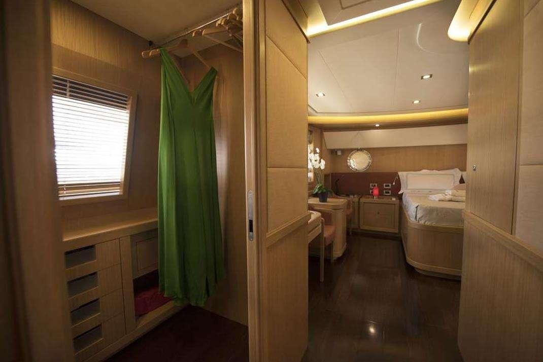 a bedroom with a green curtain aboard DANA Yacht for Charter