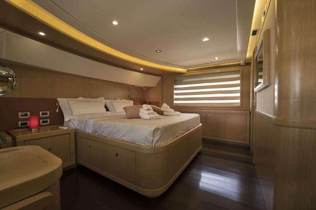 a room with a bed and a window aboard DANA Yacht for Charter