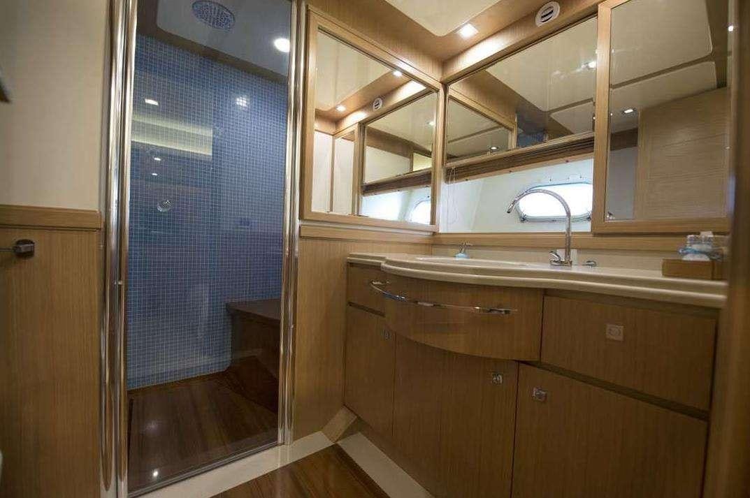 a bathroom with a glass shower aboard DANA Yacht for Charter