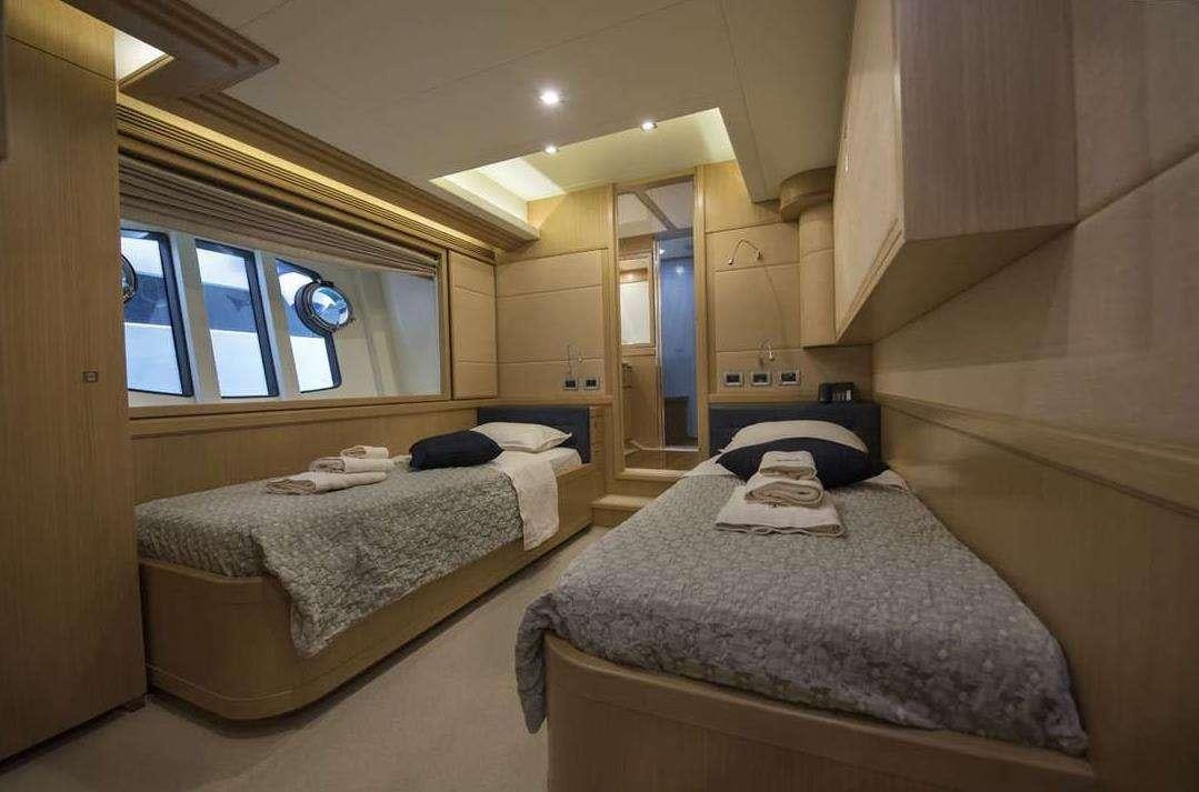 a couple of beds in a room aboard DANA Yacht for Charter