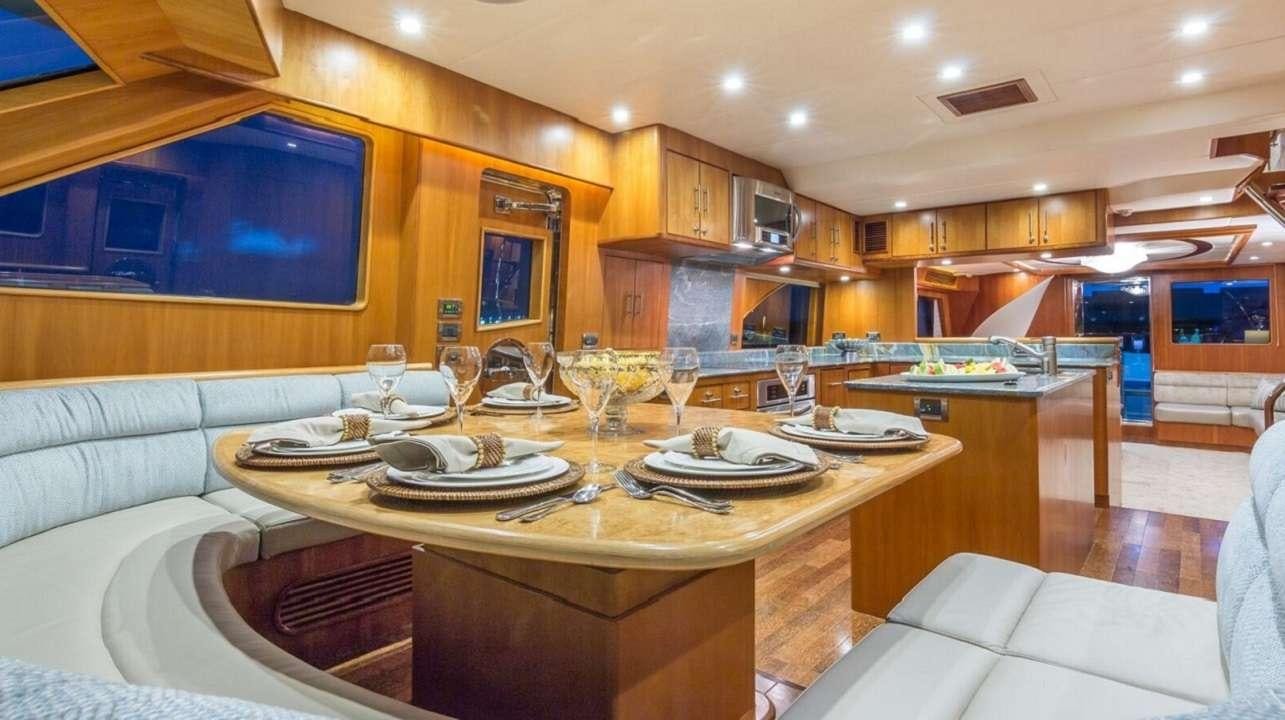a large kitchen with a table set aboard ANDIAMO Yacht for Charter