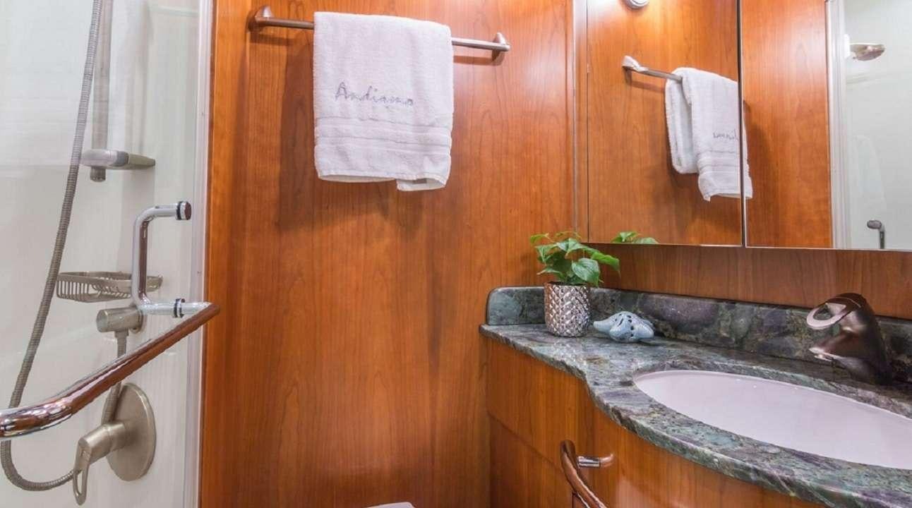 a bathroom with a sink and a mirror aboard ANDIAMO Yacht for Charter