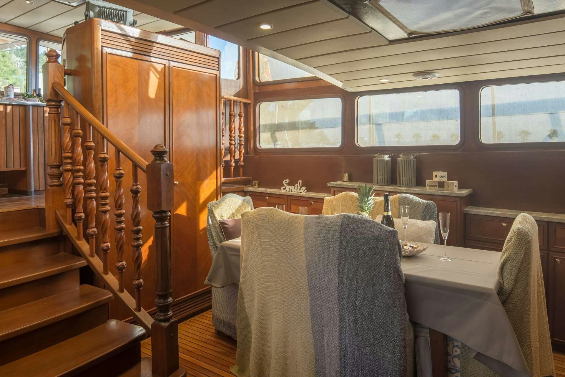 a wooden staircase in a restaurant aboard Summer Princess Yacht for Charter