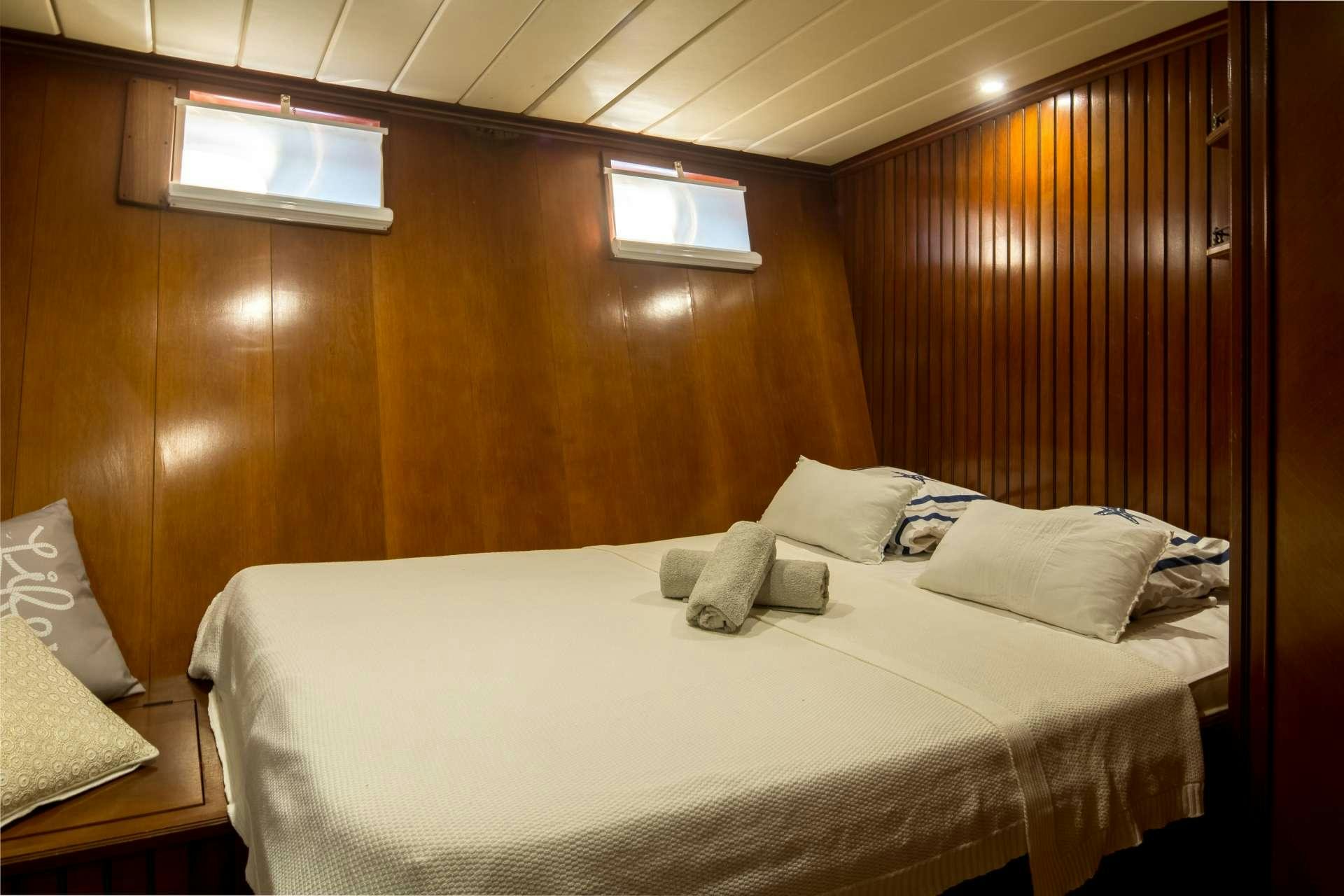 a bed with pillows on it aboard Summer Princess Yacht for Charter