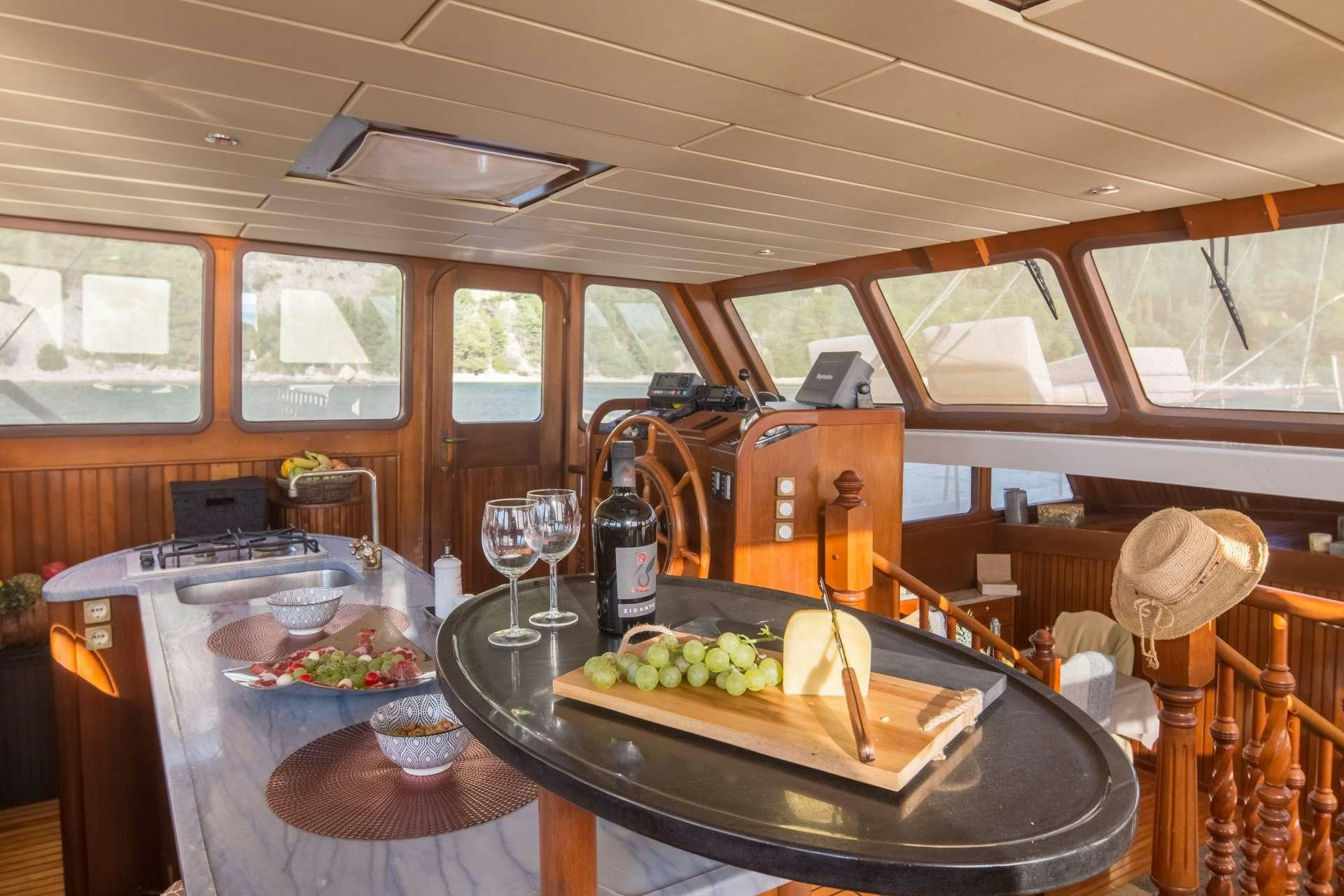 a kitchen with a large wooden table aboard Summer Princess Yacht for Charter