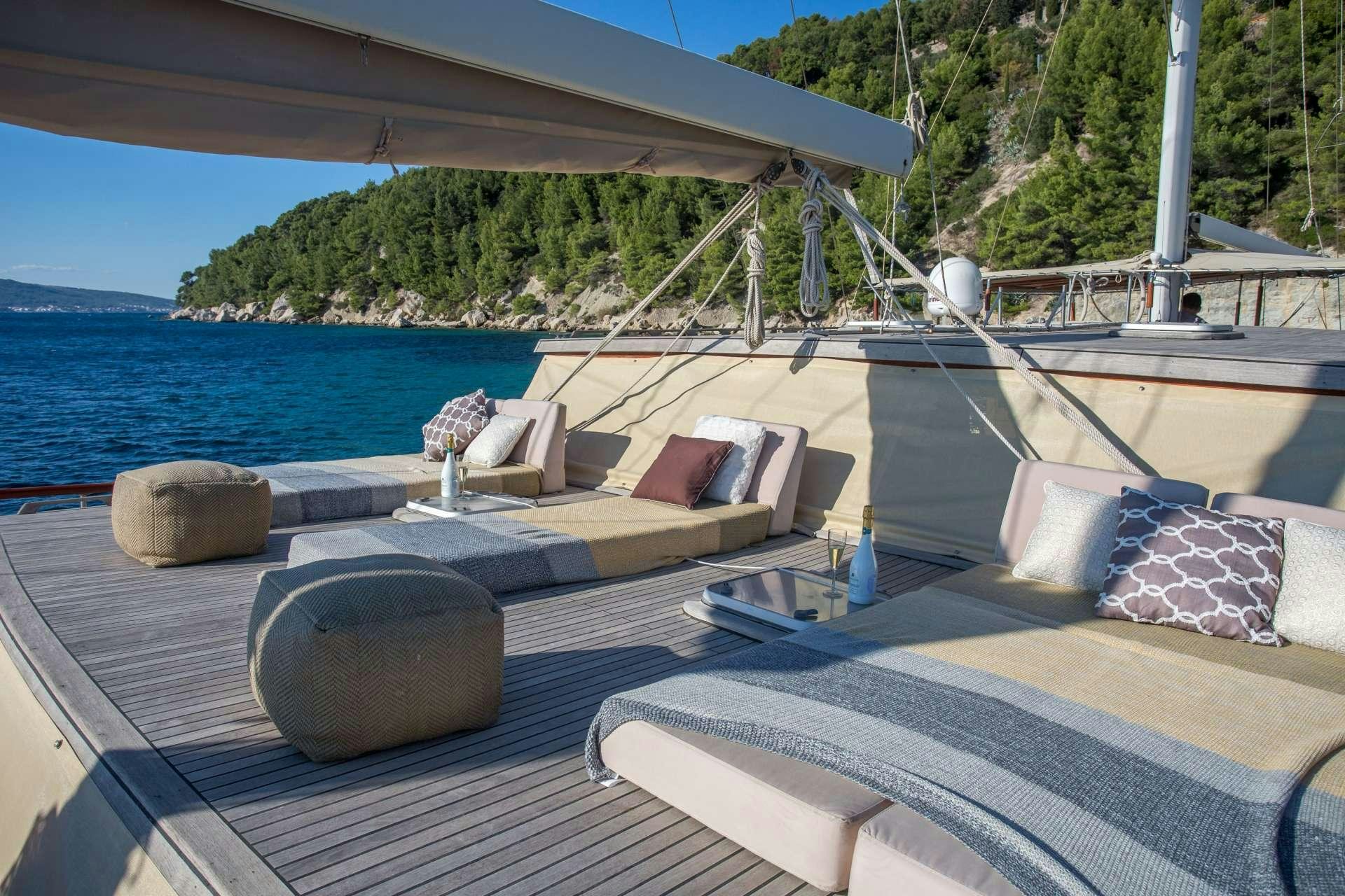a deck with a view of the water and a dock aboard Summer Princess Yacht for Charter