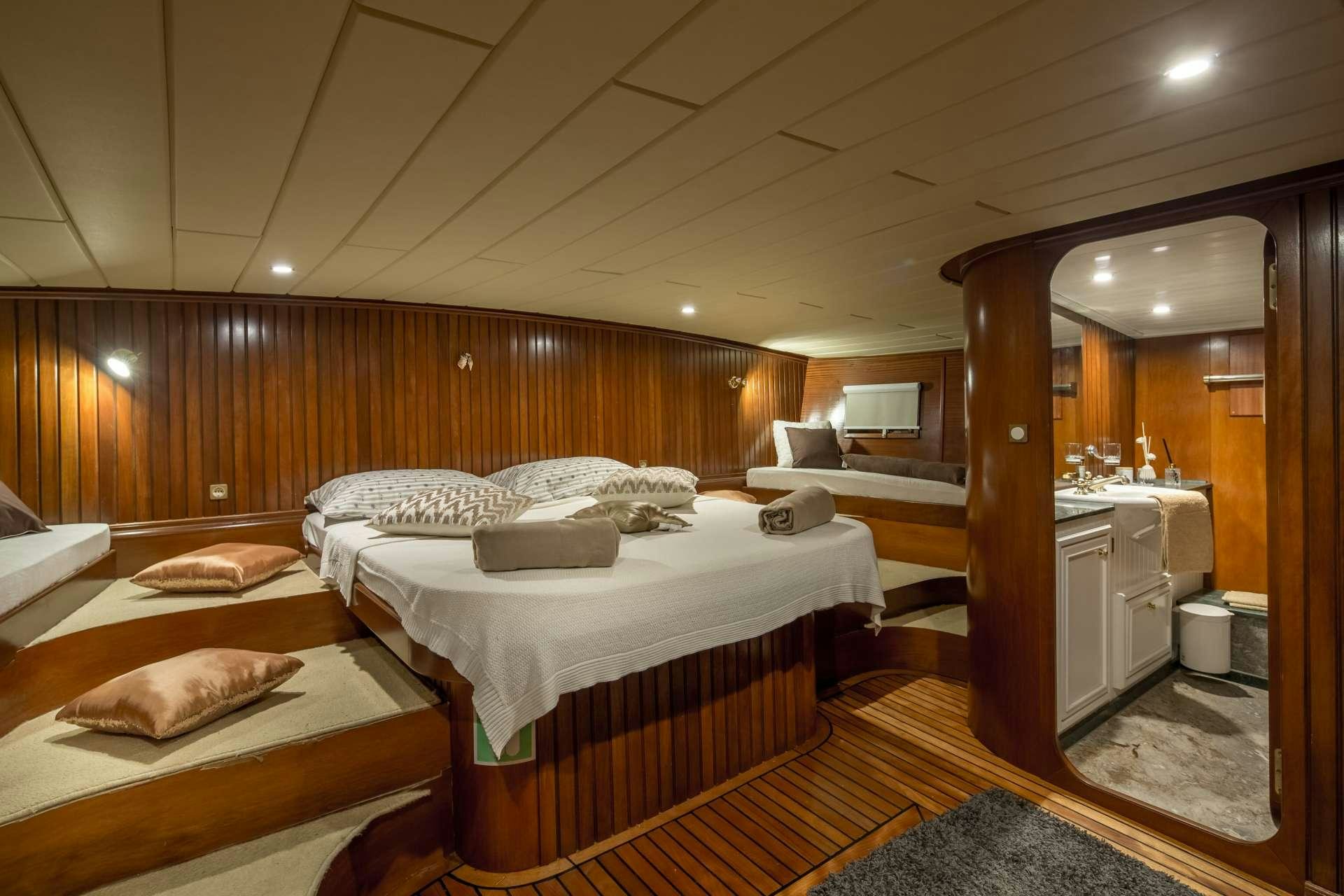 a room with beds and a mirror aboard Summer Princess Yacht for Charter
