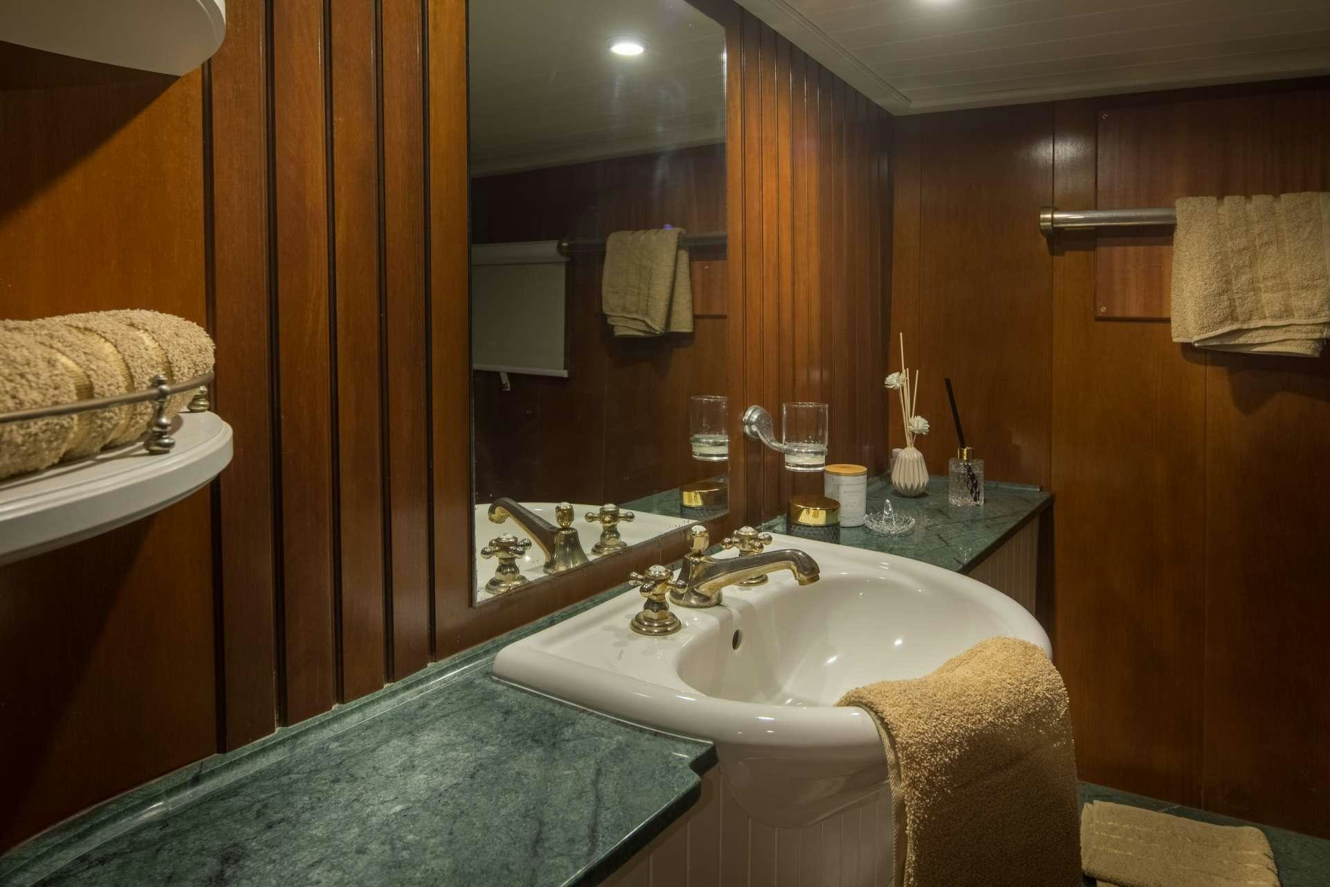 a bathroom with a sink and a mirror aboard Summer Princess Yacht for Charter