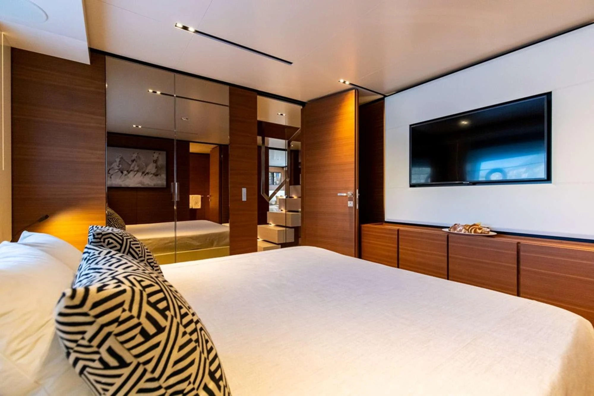 a hotel room with a bed and tv aboard PENELOPE Yacht for Charter