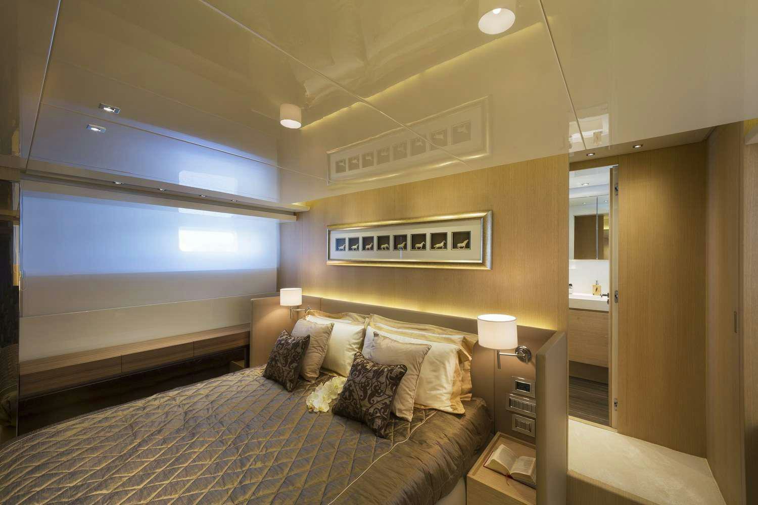 a bedroom with a bed and a desk aboard INDIGO Yacht for Charter
