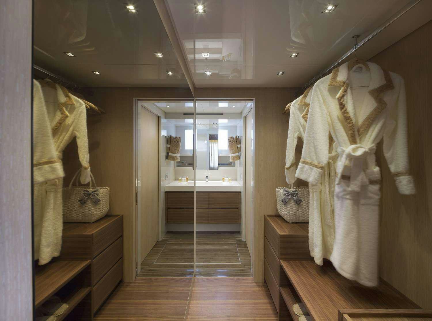 a room with a closet and a mirror aboard INDIGO Yacht for Charter