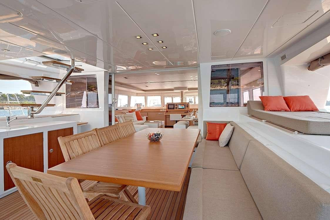 a room with a table and couches aboard FIREFLY Yacht for Charter