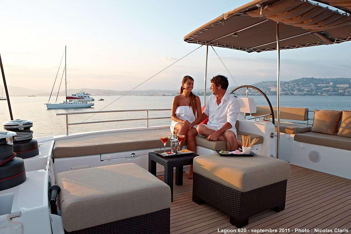 a man and a woman sitting on a boat aboard FIREFLY Yacht for Charter