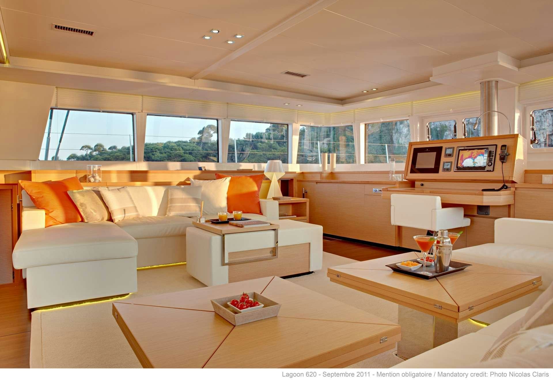 a living room with a couch and a table aboard FIREFLY Yacht for Charter