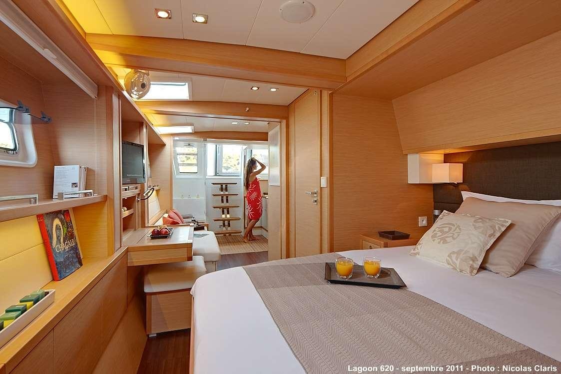 a room with a bed and a table aboard FIREFLY Yacht for Charter
