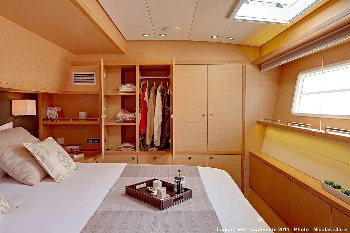 a bedroom with a bed and a desk aboard FIREFLY Yacht for Charter