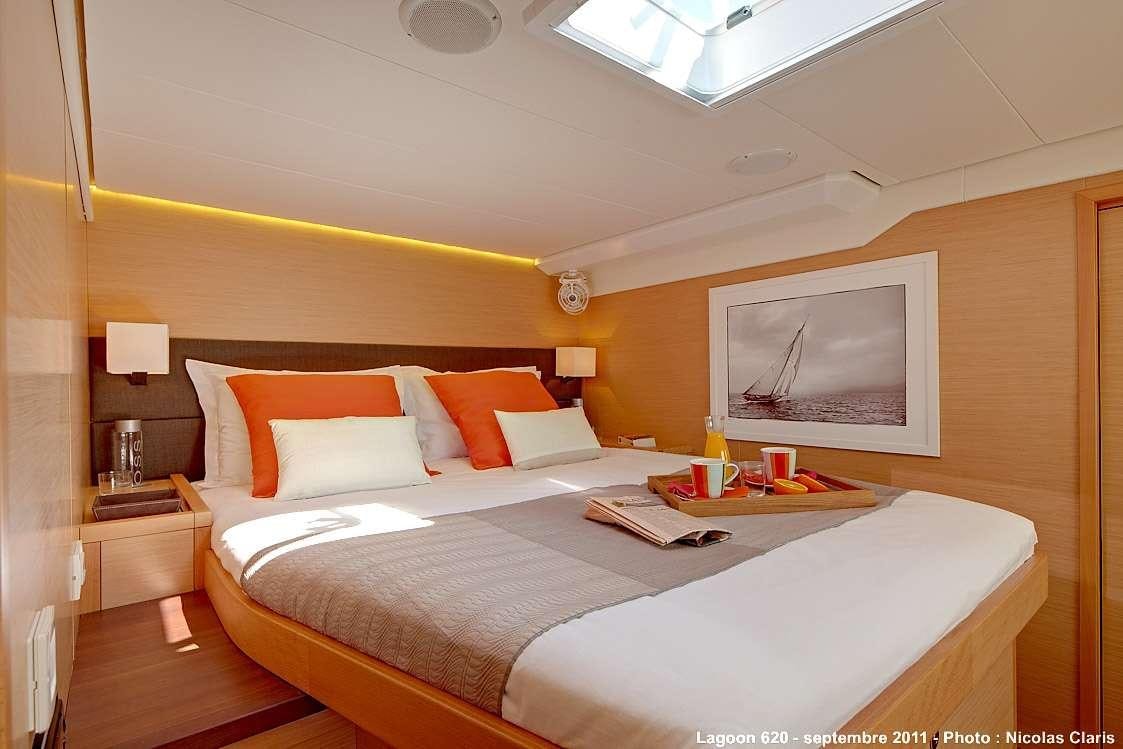 a hotel room with a bed and a television aboard FIREFLY Yacht for Charter