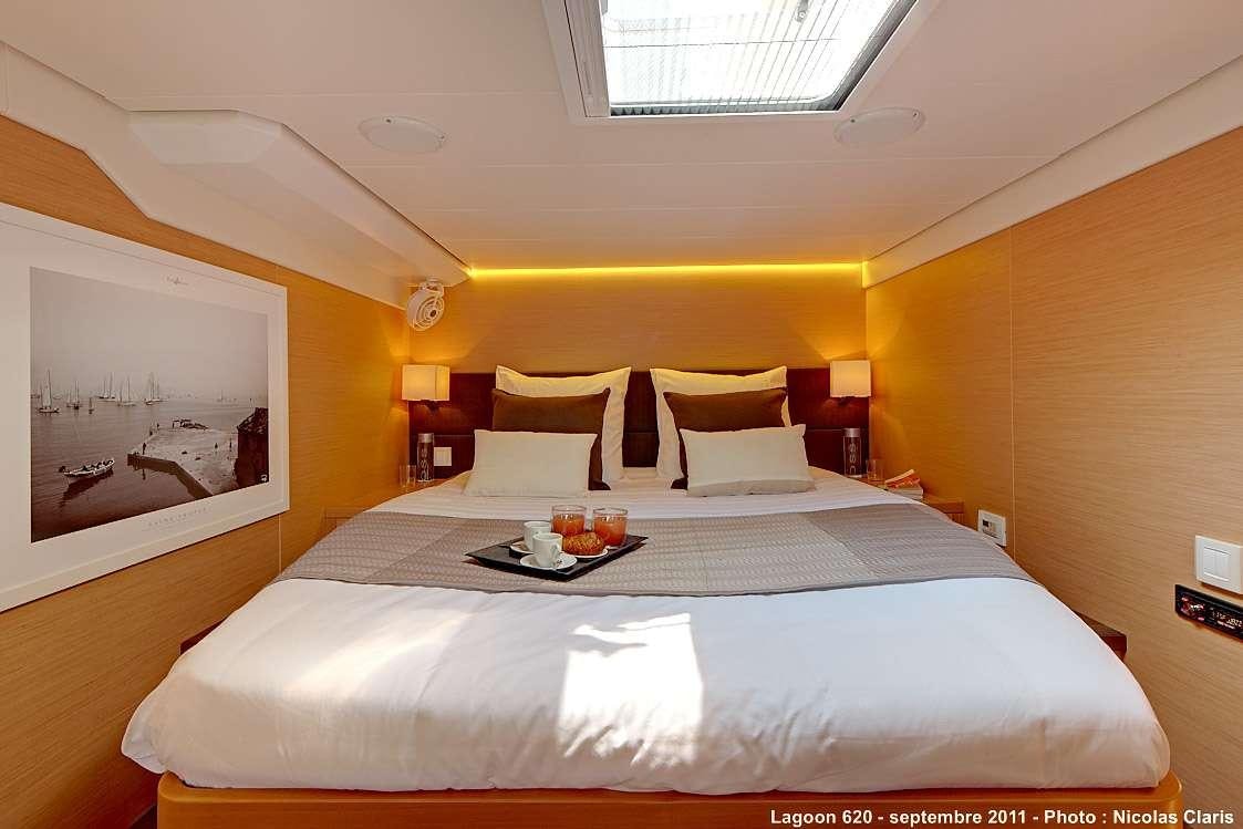 a bed with a tray of food on it aboard FIREFLY Yacht for Charter