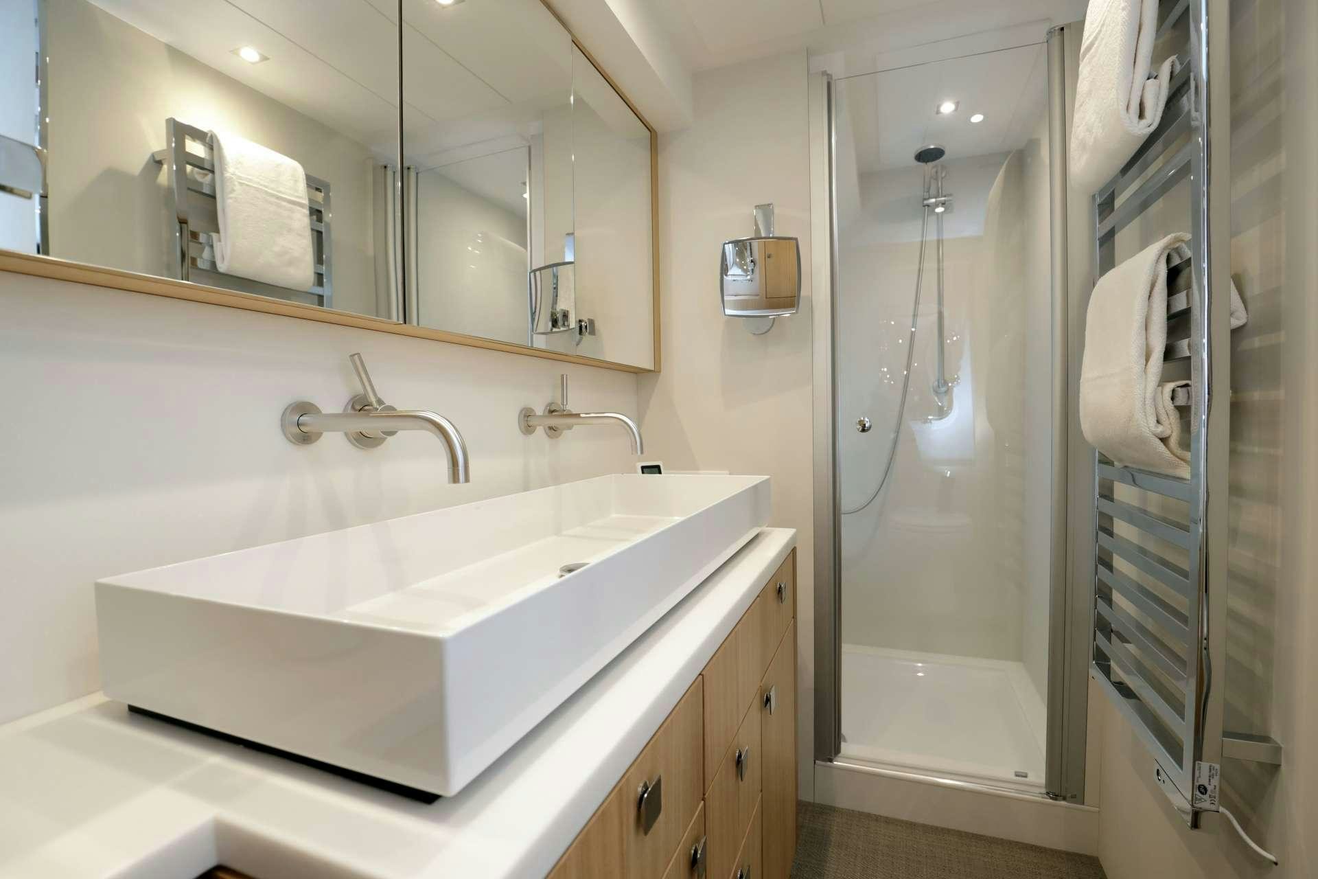 a bathroom with a large mirror aboard ARMONEE Yacht for Charter