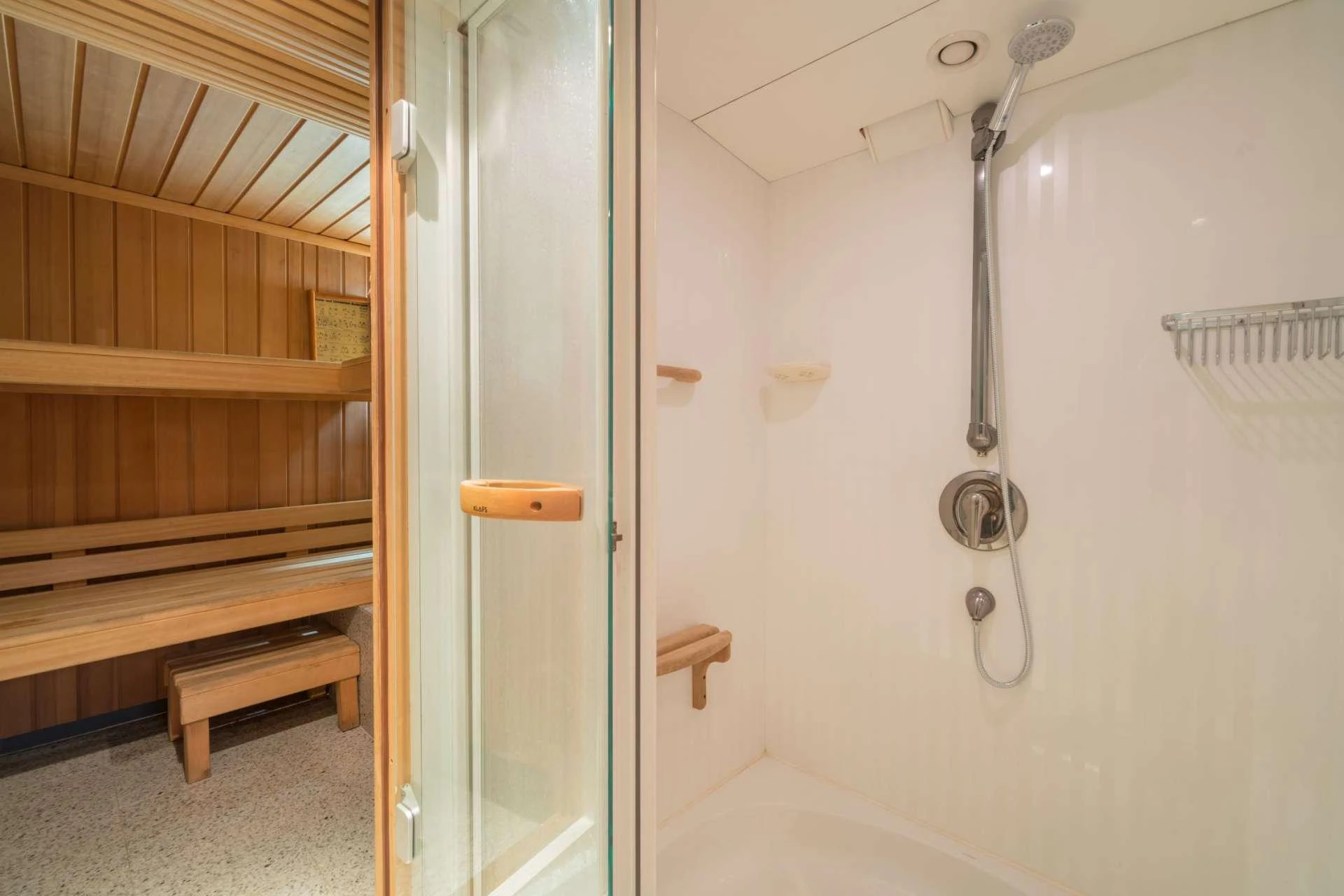 a white bathroom with a shower aboard XANADU OF LONDON Yacht for Charter