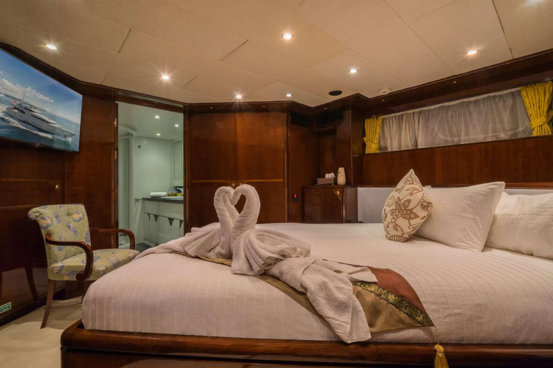 a bed with a large bed aboard XANADU OF LONDON Yacht for Charter