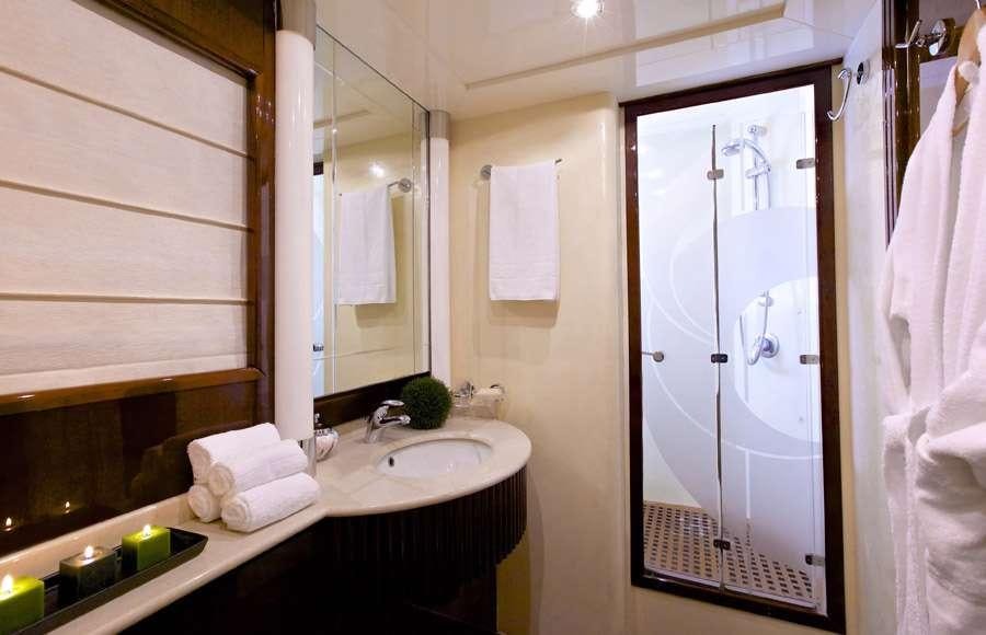 a bathroom with a shower sink and mirror aboard LET IT BE Yacht for Charter