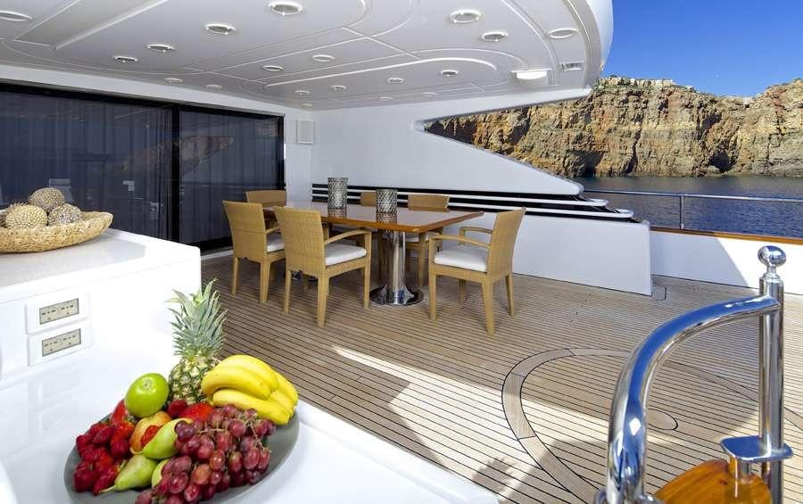 a kitchen with a table and chairs aboard LET IT BE Yacht for Charter