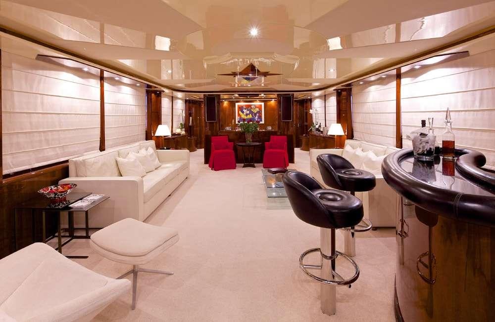 a room with a couch and a table and chairs aboard LET IT BE Yacht for Charter