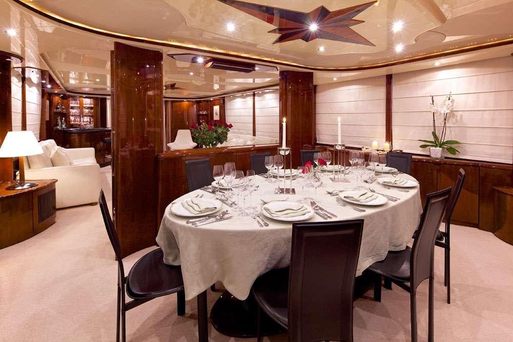a large room with tables and chairs aboard LET IT BE Yacht for Charter