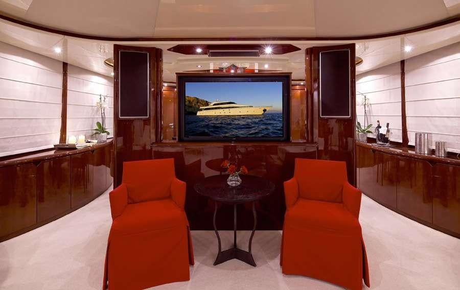 a living room with orange furniture aboard LET IT BE Yacht for Charter