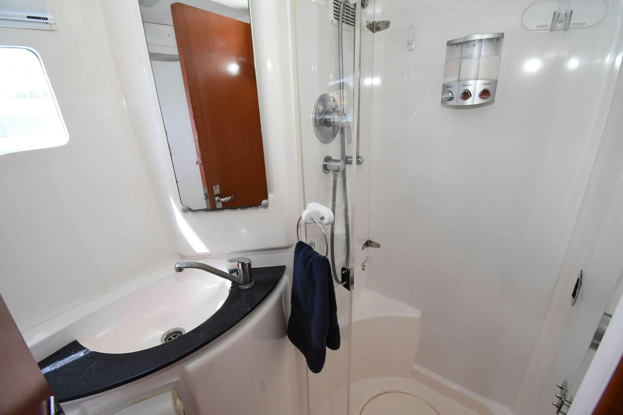 a bathroom with a sink and a mirror aboard DEEPBLUE Yacht for Charter