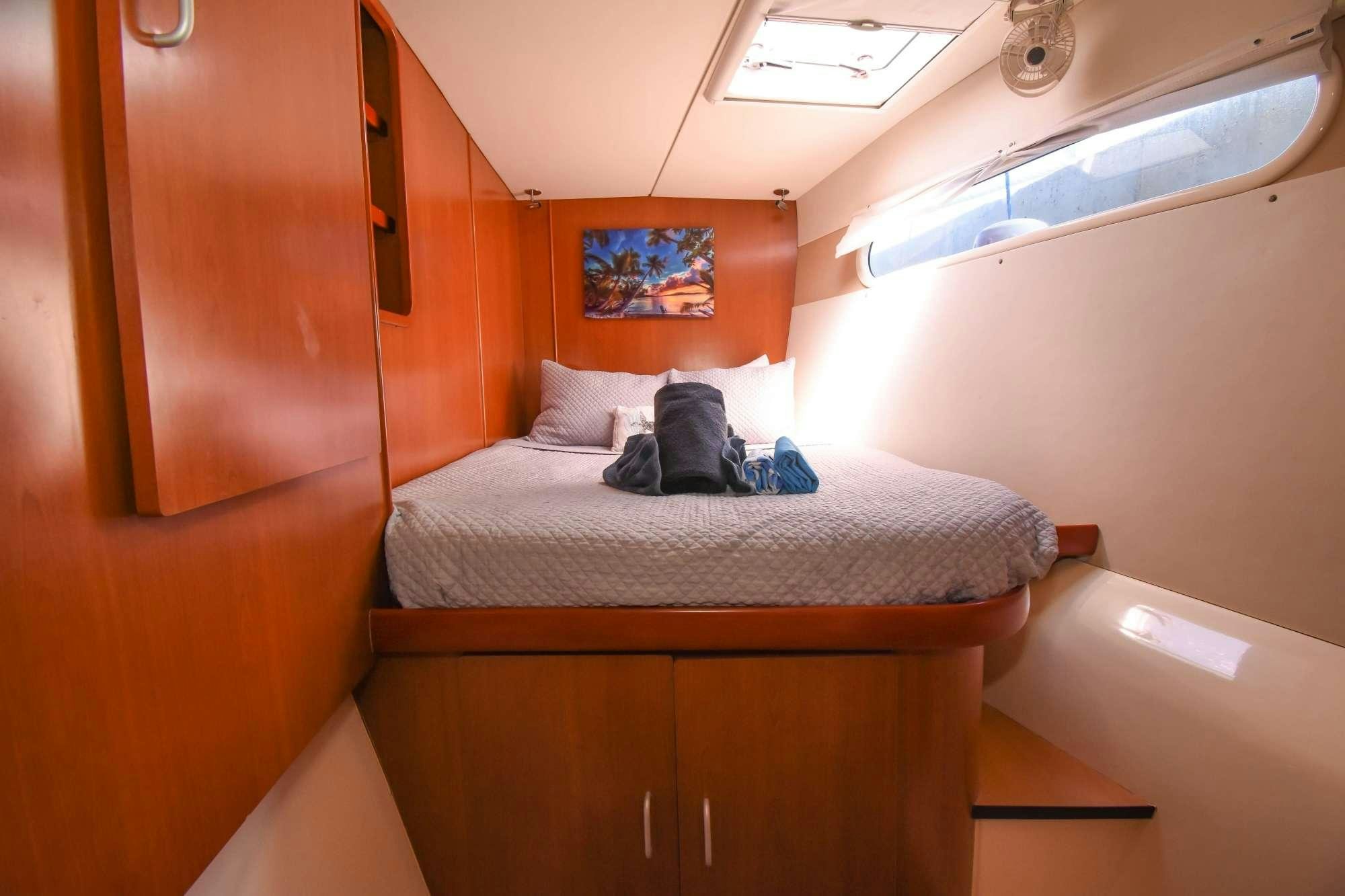 a bed with a white sheet on it aboard DEEPBLUE Yacht for Charter
